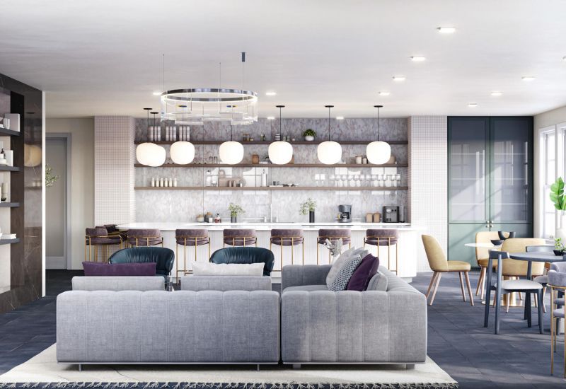 Modern lounge with a fireplace, bar area, shelves, sofas, and dining tables in a bright, open space.