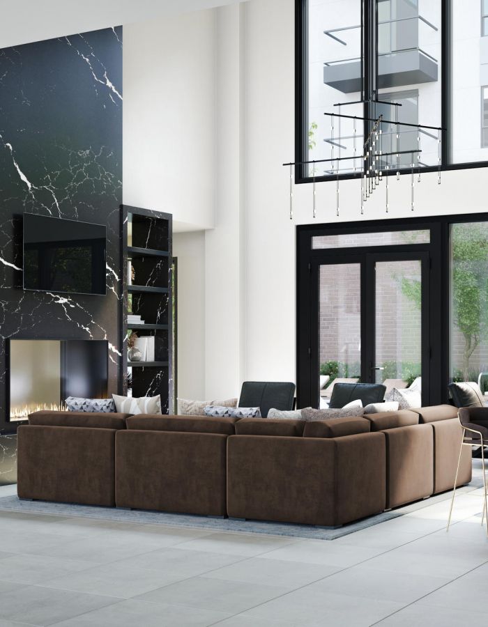 Modern living room with large windows, brown sectional sofa, marble fireplace, and dining area near a garden.