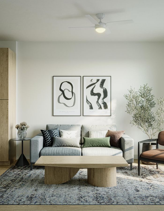 Modern living room with a gray sofa, abstract art, a wood coffee table, and a large window with natural light.