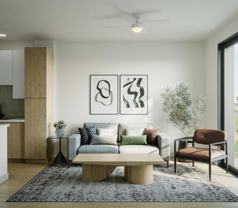 Modern living room with a gray sofa, abstract art, a wood coffee table, and a large window with natural light.